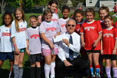 Councilman Bob Weiner presents a grant check to the Concord Soccer Association.